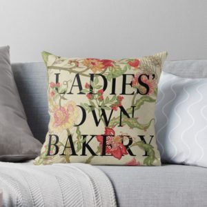 Ladies' Own Bakery Jacobin flowered print pillow on a gray sofa
